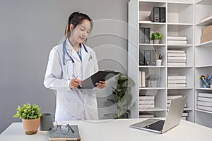 Asian female doctor stethoscope and clipboard at work, professional advice and consultation at hospital