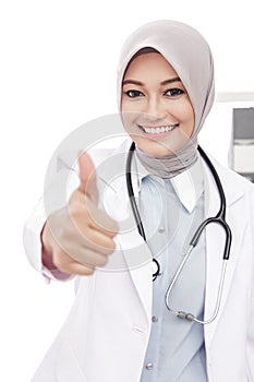 Asian female doctor with stethoscope giving thumbs up