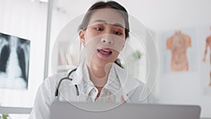 Asian female doctor using laptop computer online video call remote talking to patient, prescribe medicine