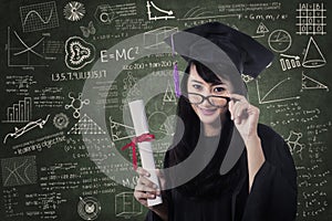 Asian female graduate in class with certificate