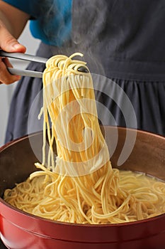 Asian Female Hand Boiled Asian Noodle Mie Telur or bakmi,