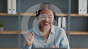 Asian Female Helpline Operator Laughing Talking Wearing Headset In Office