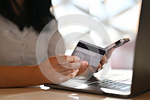 Asian female holding a smartphone and a credit card. mobile banking, credit card payment