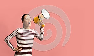 Asian Female With Megaphone In Hands Making Announcement, Shouting At Copy Space