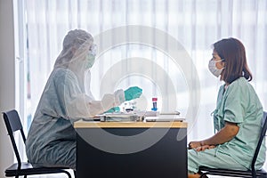 Asian Female Patient Being Reassured By Woman Doctor photo