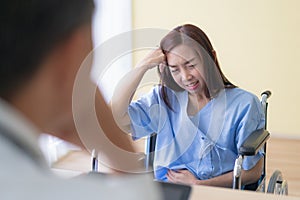 Asian female patient sitting on wheelchairs are meeting the doctor