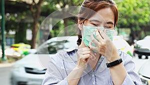 Asian female people showing how to use hygienic mask, step by step instruction, woman wearing medical face mask on street in city,