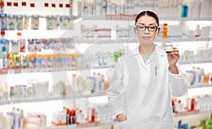 Asian female pharmacist with medicine at pharmacy