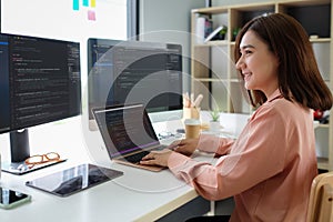 Asian female programmer working at at modern office. Developing programming