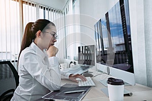 Asian female software developer is worried about analyzing code-based systems at his office photo