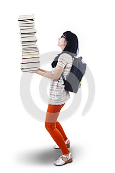 Asian female student bring pile of books - isolated