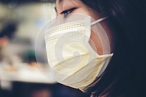 An Asian female teenager wears a surgical mask to protect against a new strain of viruses