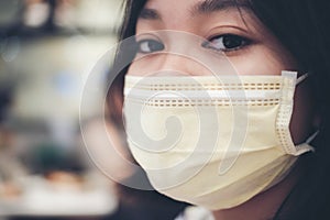 An Asian female teenager wears a surgical mask to protect against a new strain of viruses