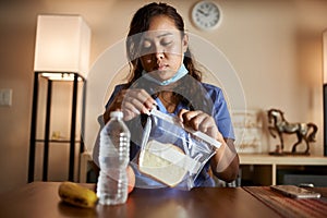 Asian filipina nurse at home packing lunch for work