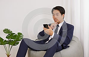 Asian Financial Advisor Thinking and Sit on Bean Bag