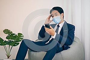 Asian Financial Advisor Wear Face Mask Serious Thinking in Vintage Tone