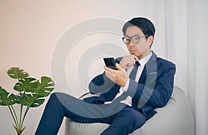 Asian Financial Advisor Wear Glasses Serious Thinking in Vintage Tone
