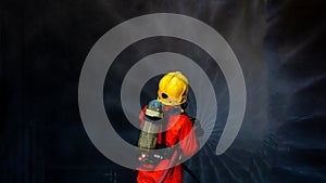 Asian firefighter on duty firefighting, Asian fireman spraying high pressure water, Fireman in fire fighting equipment uniform