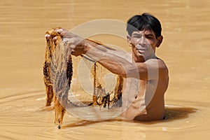 Asian fisherman with throw net