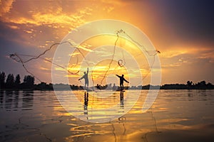 Asian Fishermen on boat fishing at lake