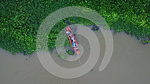 Asian fishermen on the traditional fishing boat at rural river. Fishermen on a wooden boat in the natural river.