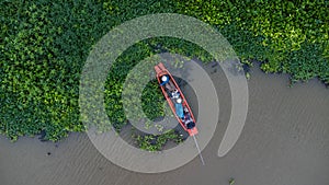 Asian fishermen on the traditional fishing boat at rural river. Fishermen on a wooden boat in the natural river. Traditional Thai