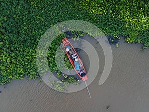 Asian fishermen on the traditional fishing boat at rural river. Fishermen on a wooden boat in the natural river. Traditional Thai