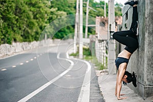 Asian fitness woman runner stretching legs and high posture after run