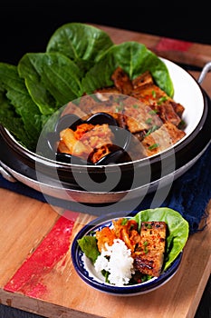 Asian food concept homemade Korean Grilled pork belly BBQ Samgyeopsal-gui with kimchi and shiso and salad on black background with