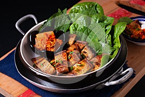 Asian food concept homemade Korean Grilled pork belly BBQ Samgyeopsal-gui with kimchi and shiso and salad on black background with