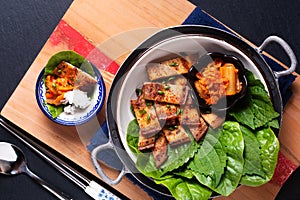 Asian food concept homemade Korean Grilled pork belly BBQ Samgyeopsal-gui with kimchi and shiso and salad on black background with