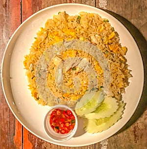 Asian Food, Crab Fired Rice Khao Phat Pu in white plate on wooden table background