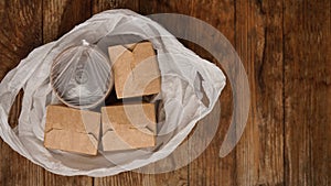 Asian food delivery. Food in containers and in a package on a wooden background