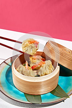 Asian food - dim sum with shrimp in steamer. Dim sum with prawn in minimal style. Modern concept asian menu. Chinese dumplings on