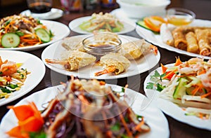 Asian food menu.Fried springrolls with shrimps and assortments of fresh salads in Vietnamese cuisine restaurant.Delicious seafood