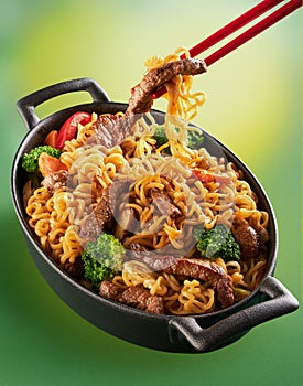 Asian food. Noodles with beef, broccoli, carrot in the metal pan. Doshirak with meat