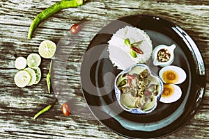 Asian food. Pork Curr Seasoned With Bird Pepper With Rice on wooden background