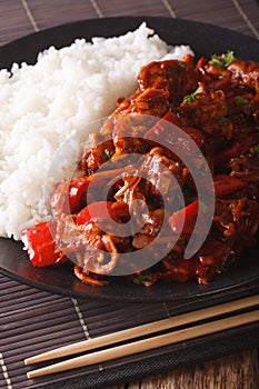 Asian Food: Rice with pork stew with vegetables closeup. vertical