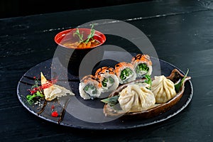 Asian food set dumplings and sushi rolls