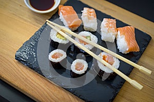 Asian food, Sushi on a wooden table on black slate plate with so