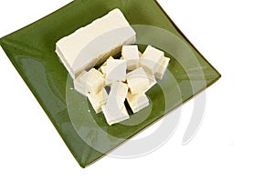 Asian food : Tofu cubes with green plate isolated on white background, top view