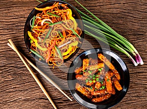 Asian food on wooden background with chop sticks