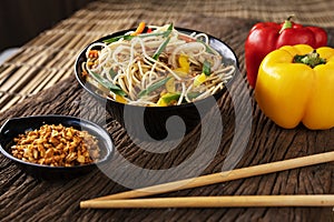 Asian food on wooden background with chop sticks