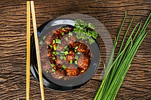 Asian food on wooden background with chop sticks