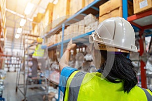 Asian Foreman and female laborer working in a warehouse.  Working Woman Concept