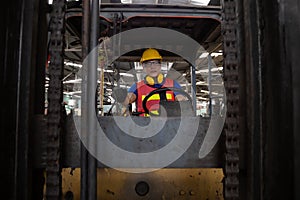 Asian forklift driver at workplace in factory