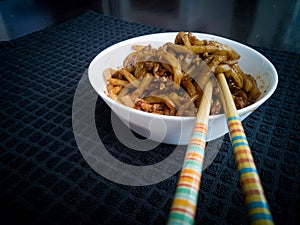 Asian fried noodles with soy sauce and eggs in a bowl.