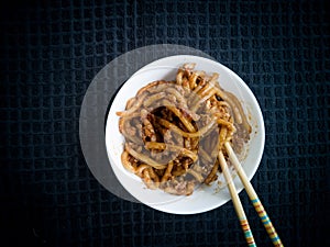 Asian fried noodles with soy sauce and eggs in a bowl.