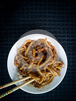 Asian fried noodles with soy sauce and eggs in a bowl.