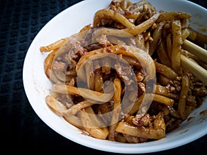 Asian fried noodles with soy sauce and eggs in a bowl.